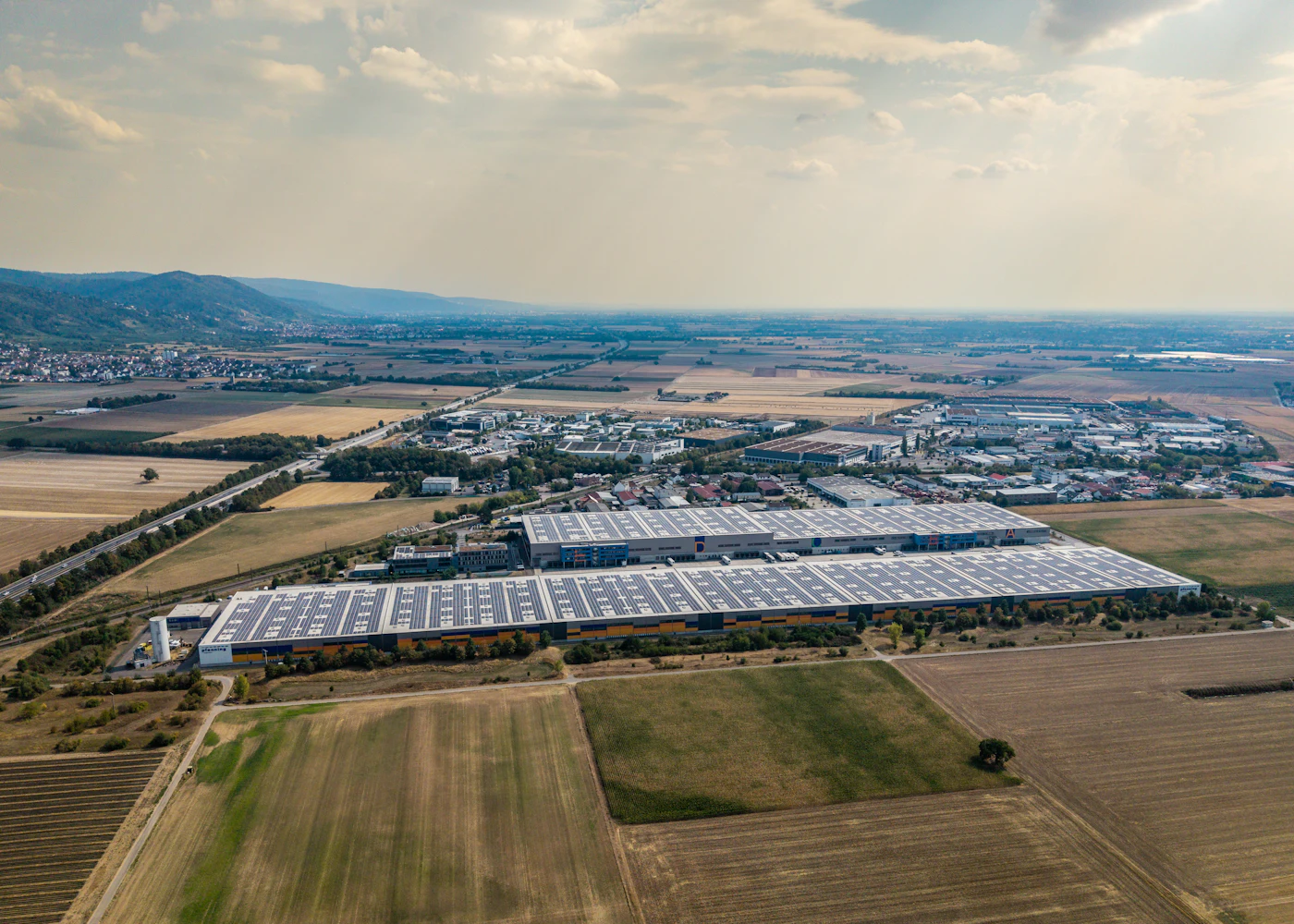 Aerial view of an industrial building with a rooftop solar array